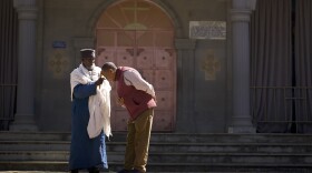 Monk performing blessing for Dr. Wassie