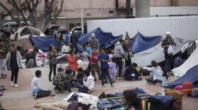 Migrants wait for access to request asylum in the US, at the El Chaparral port of Entry in Tijuana, Mexico, Monday, April 30, 2018.