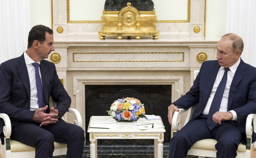 Russian President Vladimir Putin (right) hosts Syrian President Bashar al-Assad during a meeting in the Kremlin in Moscow on Sept. 13, 2021. The U.S. says Russia is recruiting Syrian fighters to help with its war effort in Ukraine.