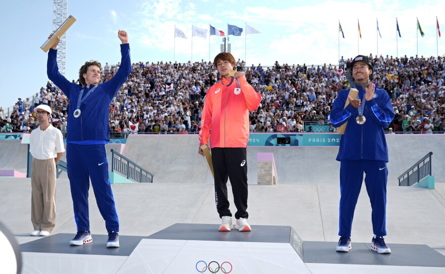 Gold medalist Yuto Horigome, of Japan, center, poses with silver medalist Jagger Eaton, of the United States, left, and bronze medalist Nyjah Huston, of the United States, after the men's skateboard street final at the 2024 Summer Olympics, Monday, July 29, 2024, in Paris, France.
