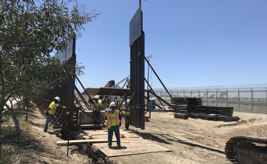 Construction crews replace fencing in Tijuana, June 30, 2018.