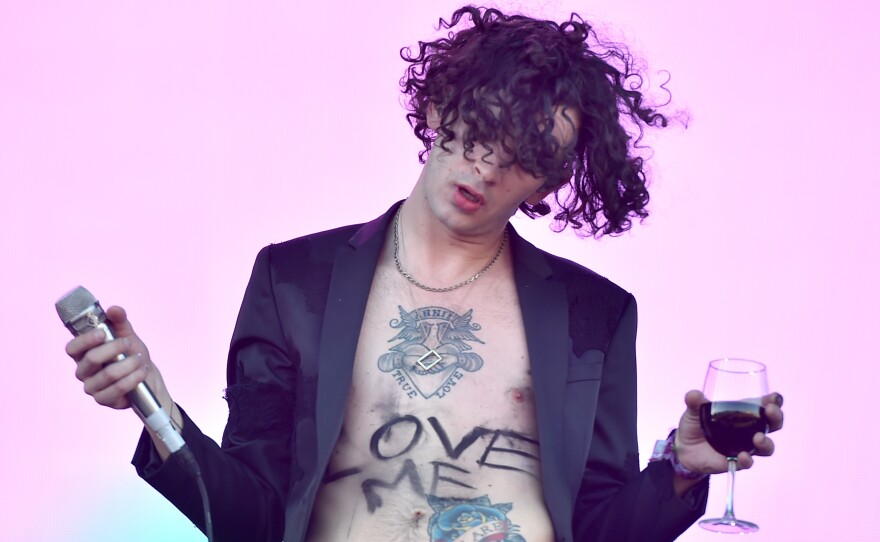 Healy (with the title of one of The 1975's self-aware songs scrawled on his stomach) performs at the Coachella Valley Music and Arts Festival in 2016.