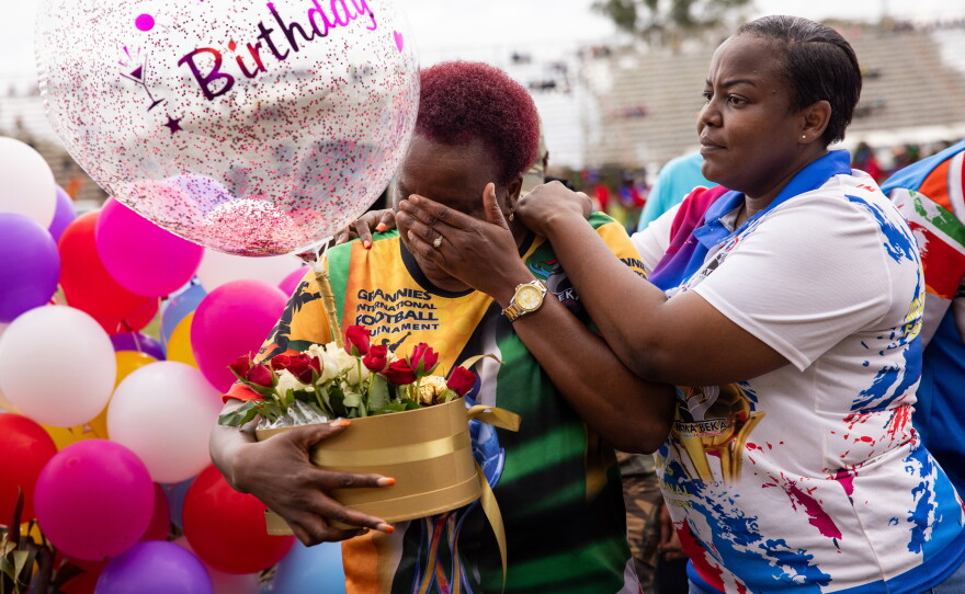 Beka Ntsanwisi (fondly known as Mama Beka) is the local philanthropist who organized the first granny games to help her town's women improve their health. Above: Ntsanwisi (center, wearing the yellow jersey) is given a surprise birthday cake on the last day of the event, when she turned 57.