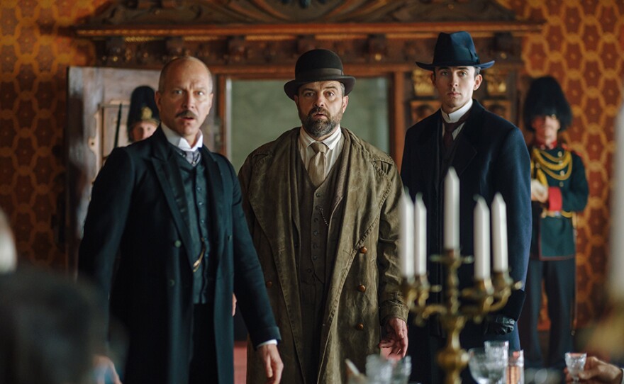 Detective Inspector Oskar Rheinhardt (Juergen Maurer), center, and psychoanalyst Max Liebermann (Matthew Beard), right, investigate a murder in Vienna’s slum quarter in VIENNA BLOOD: Season 2.