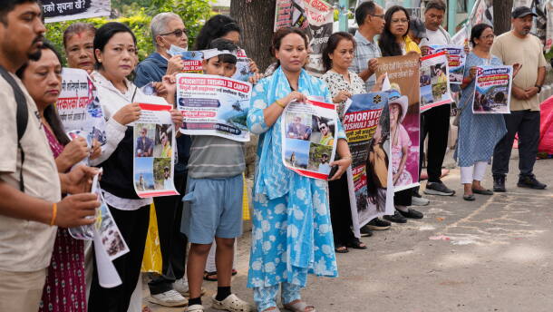 Relatives of recent flash flood victims hold banners urging authorities to step up efforts to find their missing loved ones during a demonstration in Kathmandu, Nepal, on Monday.