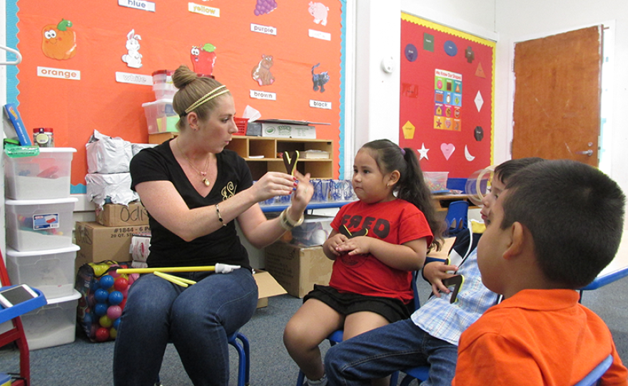 Teacher Jamie Stippel works with 4-year-old Jayla on her letters. This summer program is Jayla’s first experience with school.