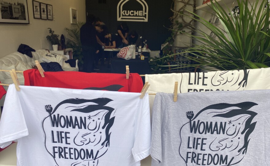 The slogan of the women's revolution on shirts hanging in Kucheh Art Studio + Shop in Washington, D.C.