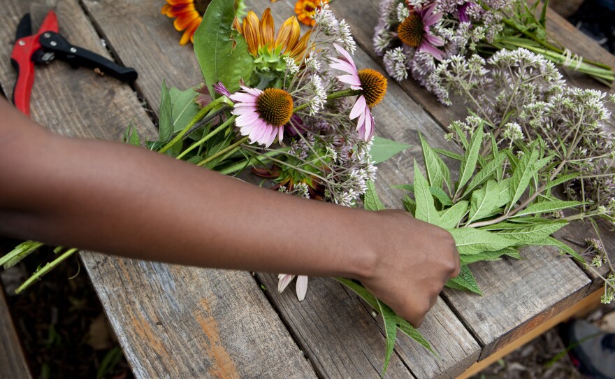 Students at Eastern Senior High School in Washington, D.C., trim bouquets to sell at the farmers market.