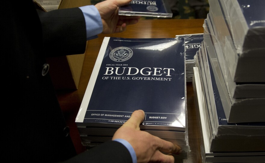Senate Budget committee staffers unpack boxes of President Obama's 2014 budget proposal on Wednesday.