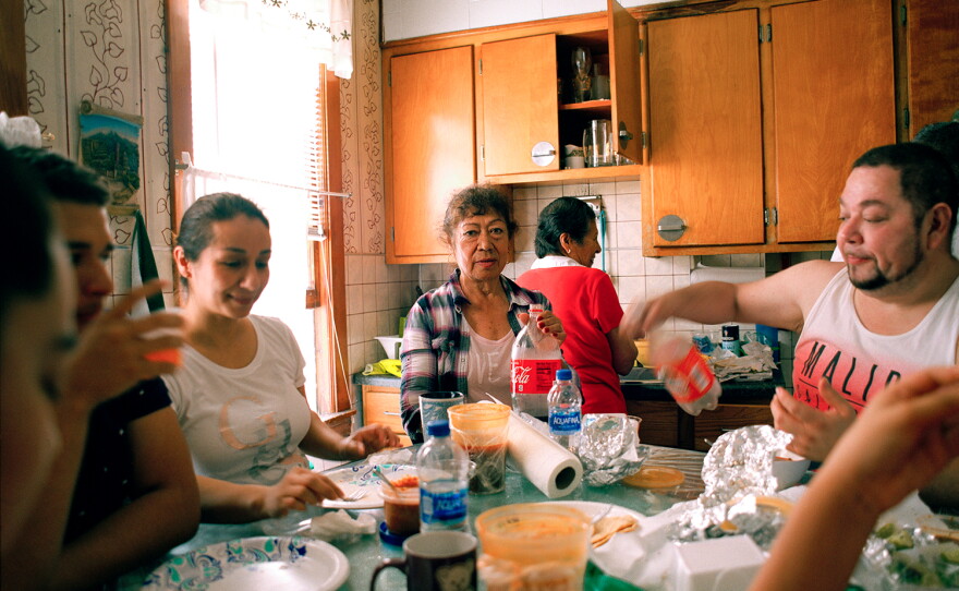 Jennifer Teresa Villanueva's aunts, cousins, grandmother and uncle gather around the dining table for an afternoon brunch at home in Chicago in 2018.