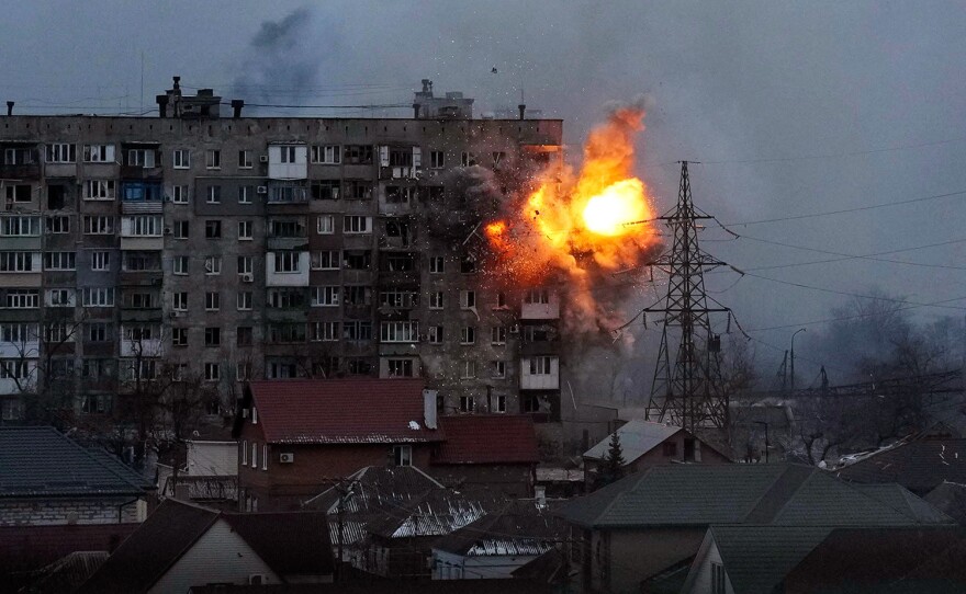 An explosion is seen in an apartment building after Russian's army tank fires in Mariupol, Ukraine, March 11, 2022. Still from FRONTLINE PBS and AP’s feature film “20 Days in Mariupol.”