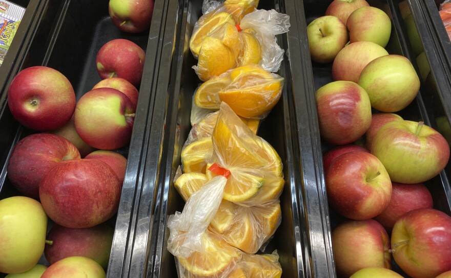 Apples and orange slices rest in trays for student lunch at Albert D. Lawton Intermediate School in Essex Junction, Vt., on June 9, 2022.