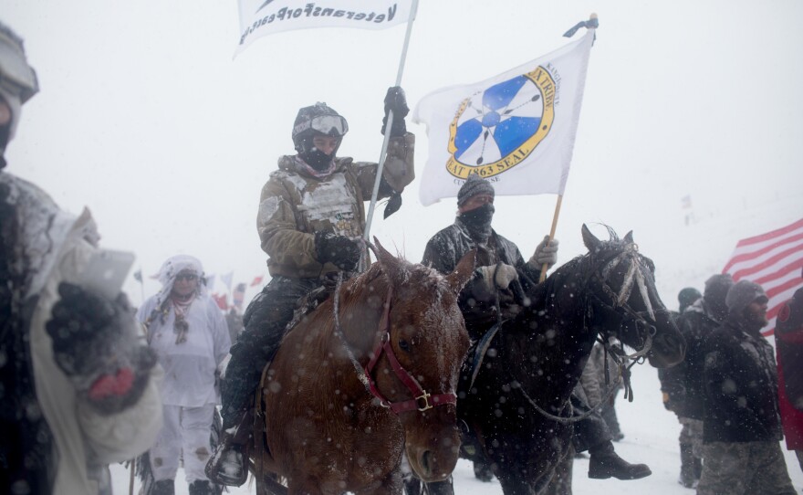 "Water protectors" and veterans march to the front lines at Backwater Bridge on Monday.