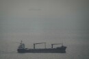 A cargo ship carrying vehicles sails through the Arabian Gulf toward the Strait of Hormuz in the United Arab Emirates, Sunday, March 22, 2026.