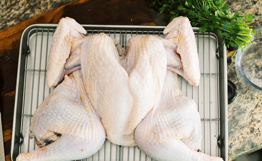 To spatchcock your turkey, you need to remove the backbone and flatten the bird.