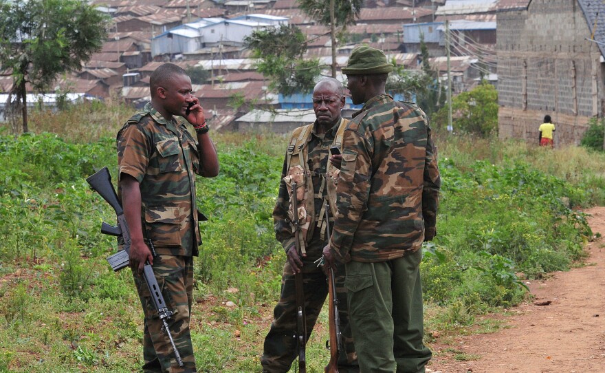 Kenya Wildlife Service officers carrying tranquilizer guns take part in a search for lions that left Nairobi National Park in Nairobi on Friday.