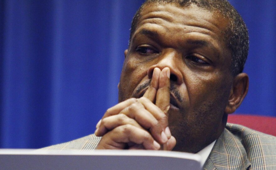 Superintendent John Covington listens to citizens during a meeting of the Kansas City, Mo., school board on Wednesday. The board voted to close nearly half the district's schools in a desperate bid to stay afloat.