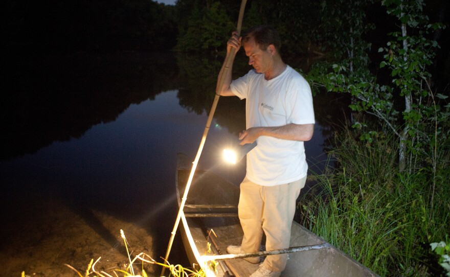 Tommy Peebles shines a light on the pond. With the help of Bick Boyte, the two Tennesseans catch frogs with homemade "gigs" for a frog leg fry they hold every year.