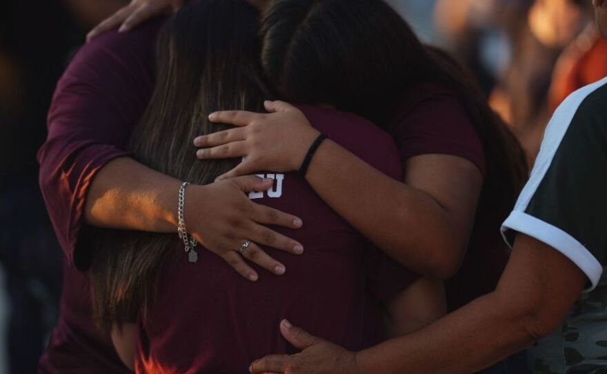 People mourn Wednesday as they attend a vigil for the victims of the mass shooting at Robb Elementary School in Uvalde, Texas.