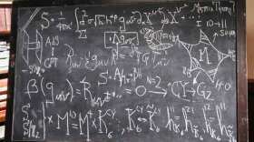 Equations for string theory and general relativity are displayed on a blackboard as a visual reminder that the ideas underlying these theories are grounded in mathematics.