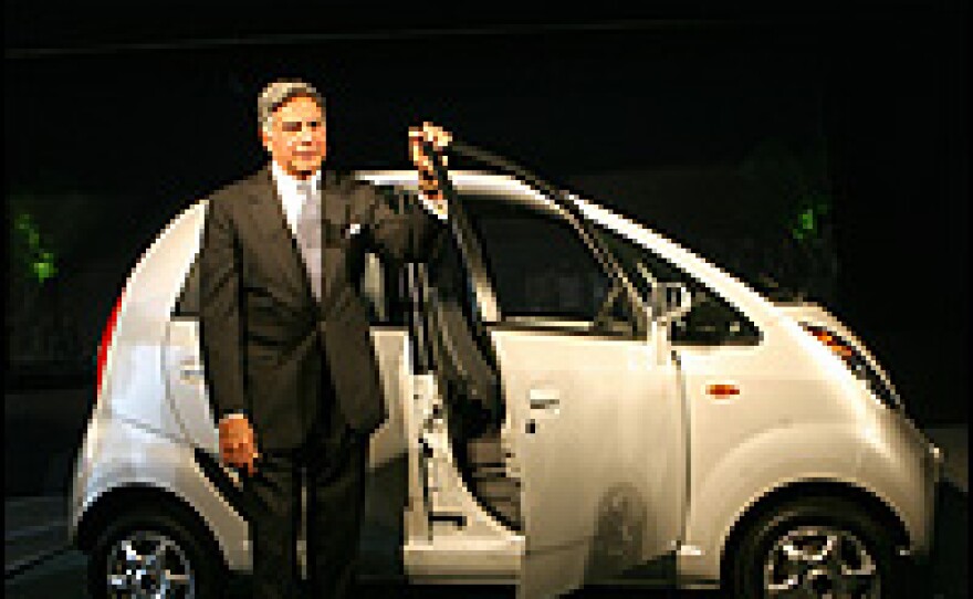 Tata Group Chairman Ratan Tata poses with the Nano.