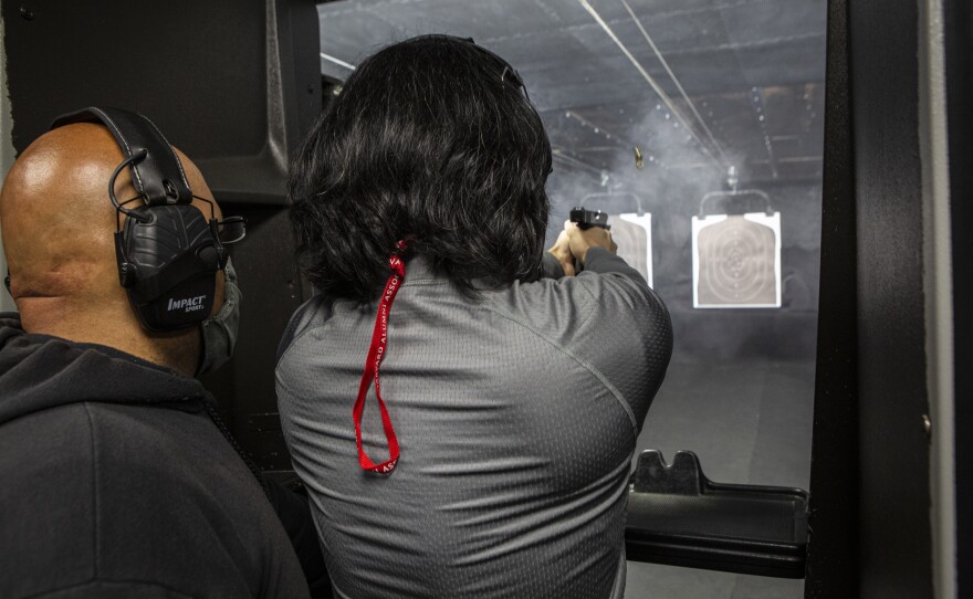 Edmon Muradyan, left, instructs Allen Soong, 47, at the shooting range on Saturday.