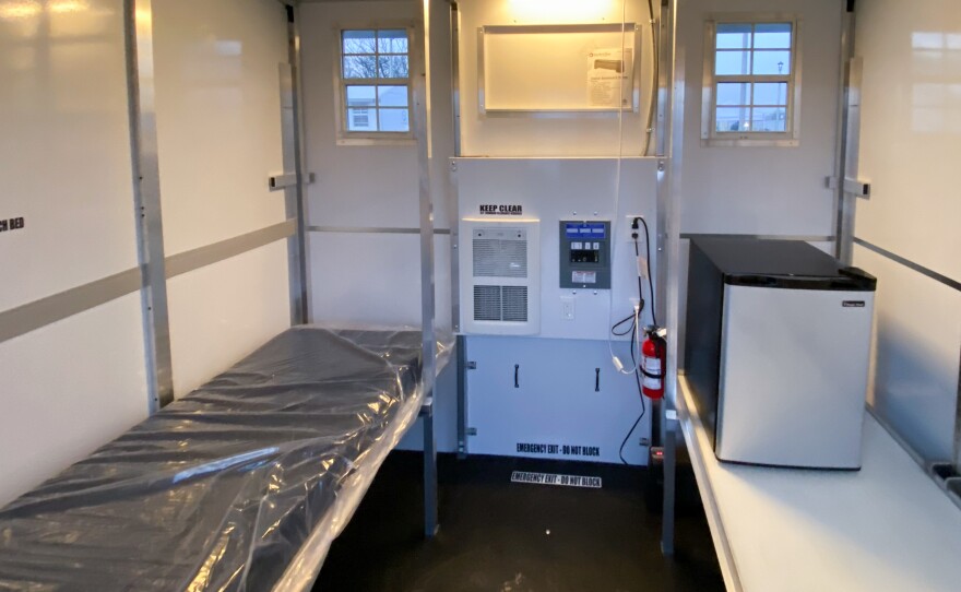 These 8-foot-by-8-foot prefabricated shelters in a tiny home village on the outskirts of Madison, Wisconsin in December, 2021 have room for a cot, a refrigerator, and some personal belongings.