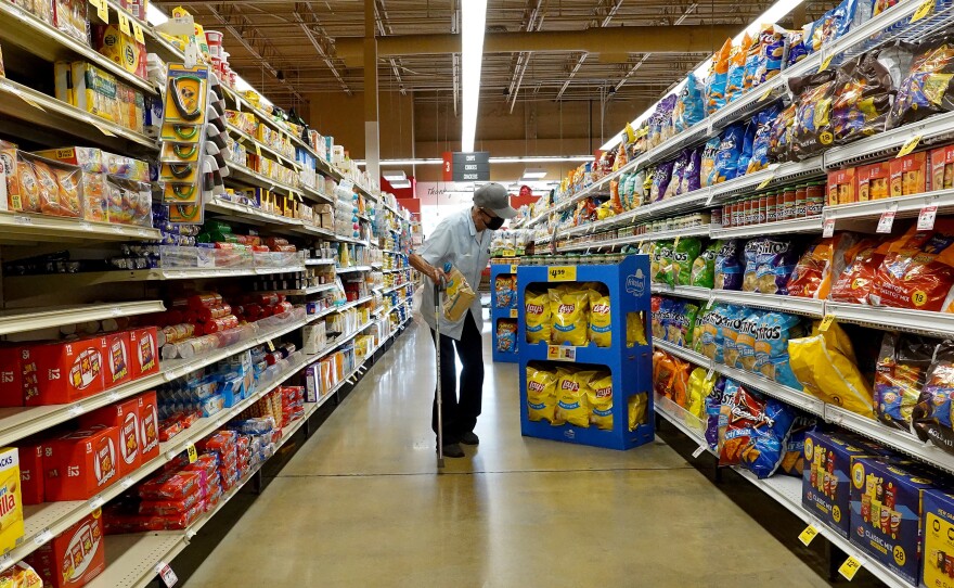 Tackling inflation remains a top priority for the Federal Reserve and the Biden administration. Here, a customer shops at a grocery store in Miami on Feb. 10.