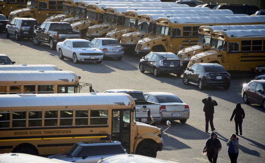 Los Angeles Unified school district buses sit idle following an "electronic threat" on Tuesday. More than 600,000 students were being sent home or told not to come to school.