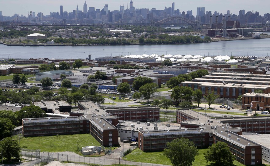 The Rikers Island jail complex in New York with the Manhattan skyline in the background. New York City lawmakers voted on Thursday to close the notorious jail complex.