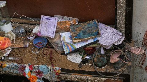 Books, shoes and other stuff of victim children are seen at the site of Tuesday's roof collapse at a tutoring center roof, on the outskirts of Lahore, Pakistan, Wednesday, July 1, 2026.