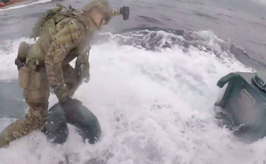 U.S. Coast Guard Cutter Munro crew members board a semi-submersible suspected of carrying drugs on June 18 while operating in international waters of the Eastern Pacific Ocean.