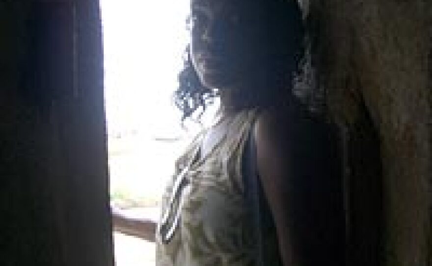 Renee Bovelle stands at the narrow exit of the dungeon leading from the Door of No Return, through which Africans left Ghana as slaves for the New World.