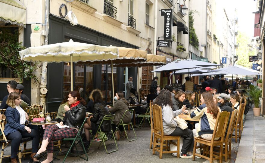 Diners sit outdoors on terraces in Paris on May 19, 2021, as cafes, restaurants and other businesses reopened as part of an easing of France's lockdown due to COVID-19.