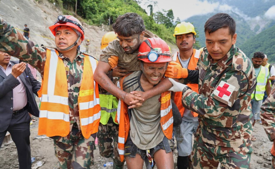 In this photo provided by the Nepal Army, soldiers rescue a worker alive from a tunnel during an ongoing operation at the Trishuli-3A hydropower project in Nepal's Rasuwa district, Friday, Sept. 4, 2026.