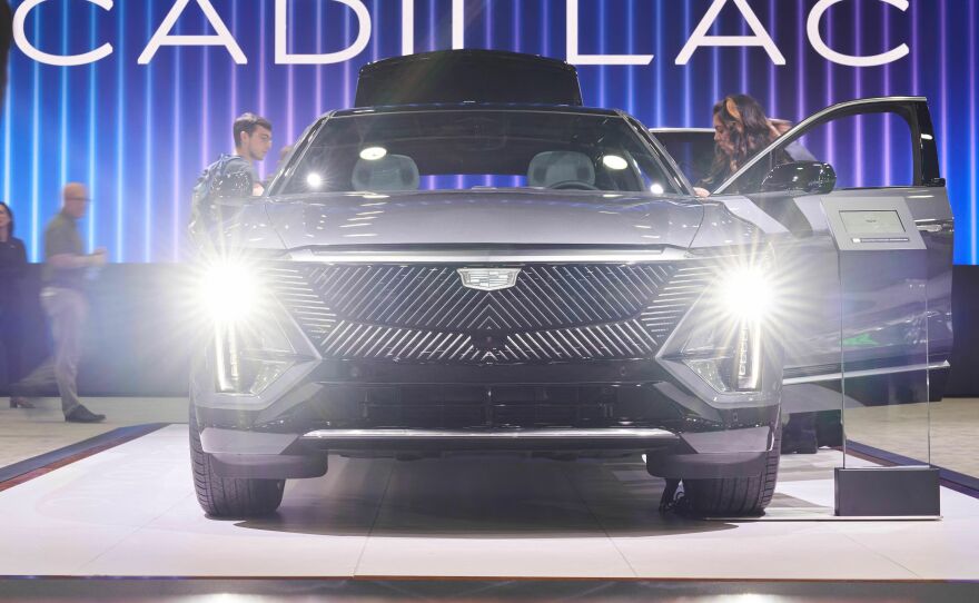 People look at the Cadillac Lyriq at the North American International Auto Show in Detroit on Sept. 14, 2022. The electric car should still qualify for the full tax credit under the latest IRS guidelines, according to General Motors.