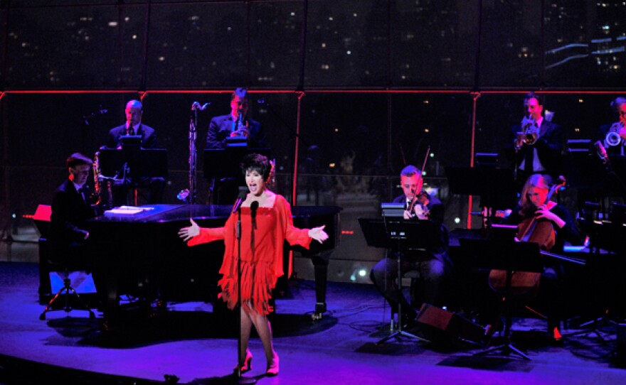 Chita Rivera on stage, accompanied by an 11-piece orchestra led by her music director Michael Croiter, and long-time associate music director/pianist Michael Patrick Walker and bassist Jim Donica.