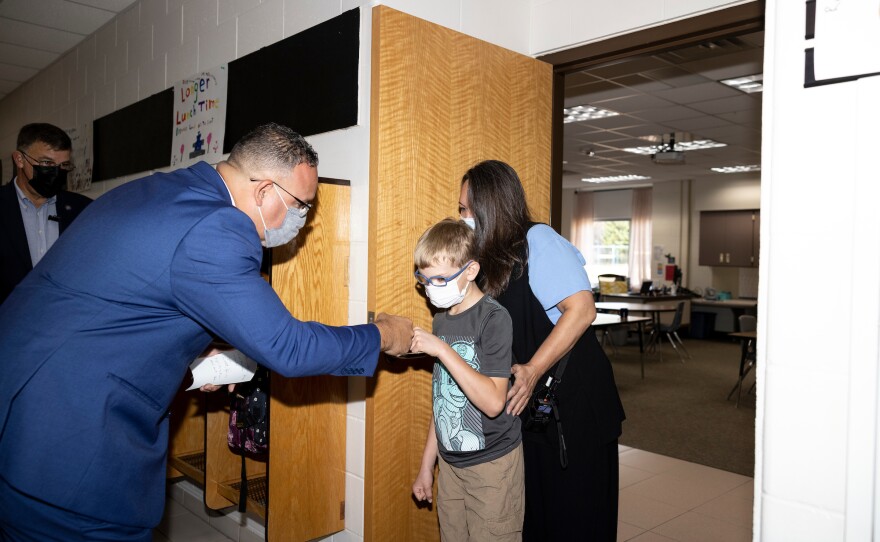 Cardona greets a student with a fist bump at Locust Lane Elementary School in Eau Claire.