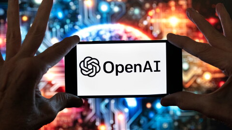 FILE - The OpenAI logo is displayed on a cell phone in front of an image generated by ChatGPT's Dall-E text-to-image model, Dec. 8, 2023, in Boston.