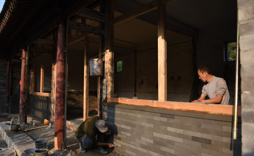 Migrant workers repair and restore a Buddhist temple in the far reaches of northern Beijing. The workers live together in a row of shanties at the bottom of the hill on which the temple rests.