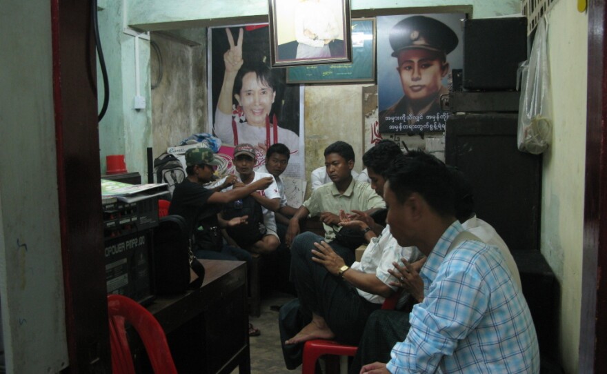 National League for Democracy members sit in the party's youth division office under pictures of party leader Aung San Suu Kyi, and her father, Burmese independence hero Gen. Aung San.