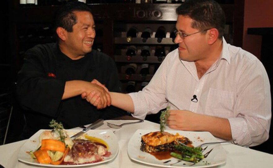 Host Jorge Meraz (right) samples food from Mujeres Divinas restaurant.