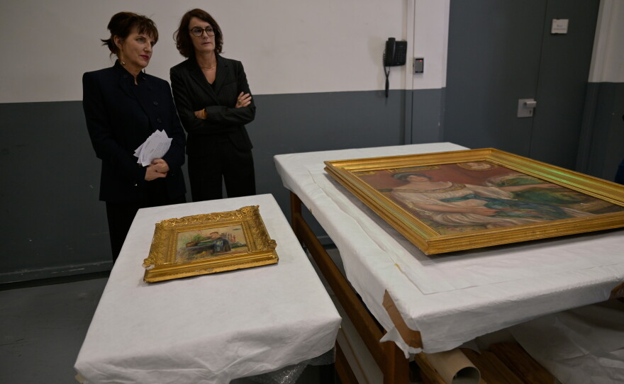 Recovered paintings "Portrait of Madame Colonna Romano" right, and "Young Woman at the Well," stolen from the Renoir Museum in Cagnes-sur-Mer are on display at the Interdisciplinary Centre for the Conservation and Restoration of Heritage in Marseille, France, Monday Oct. 12, 2026.