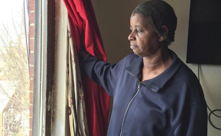 Walker's mother, Patsy Yates, shows where cold air comes in around the window frames. She says it's so cold sometimes that she boils pots of water on the stove to help warm the apartment.