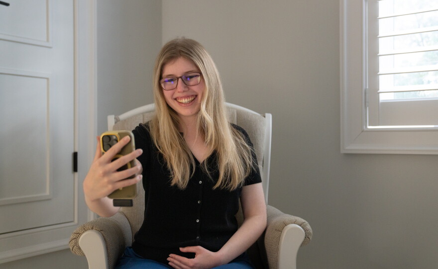 Kaleigh Brendle sits in a rocking chair she inherited from her grandmother. Here, she often makes TikToks for Judy's League, a disability rights organization she started last year.