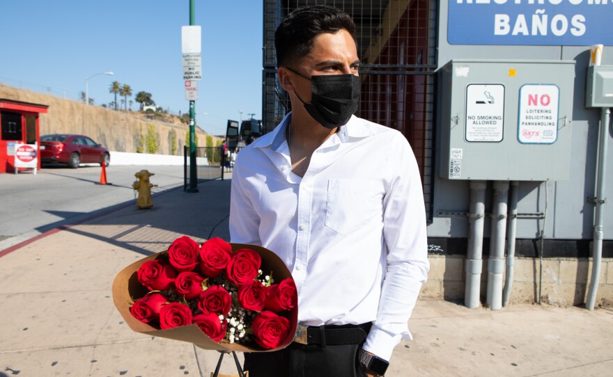 Emmanuel Alvarado waits for an Uber driver to arrive at the San Ysidro Transit Center, June 3, 2021. He was traveling from Tijuana to attend his girlfriend's high school graduation.