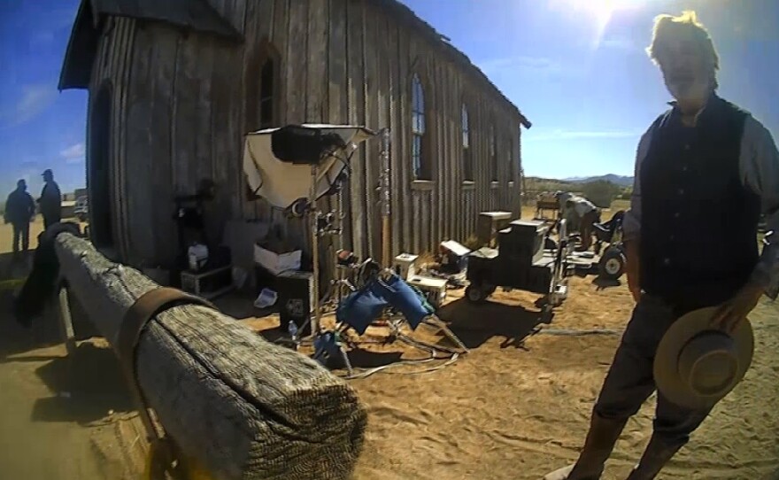 In this image from video released by the Santa Fe County Sheriff's Office, Alec Baldwin stands in costume and speaks with investigators following a fatal shooting last year on a movie set in Santa Fe, N.M.