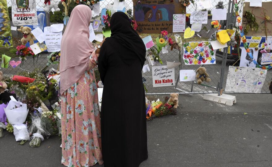 Women look at tributes left at the Linwood Islamic Centre in Christchurch, New Zealand, following the March 15 massacre at two mosques.