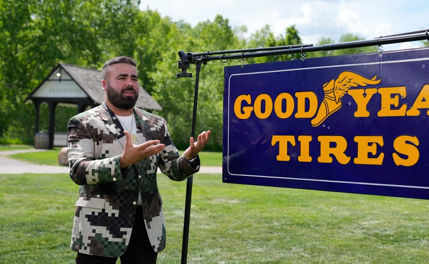 Travis Landry (left) appraises a Goodyear Tires double-sided porcelain sign, ca. 1935, in Littleton, CO. ANTIQUES ROADSHOW “Junk in the Trunk 14!” airs Monday, May 19 at 8/7C PM on PBS. Photo by GBH for GBH, © 2025 WGBH Educational Foundation
