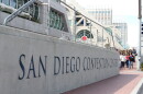 A group waits to cross Harbor Drive in front of the San Diego Convention Center. 